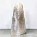 Kindred Crystal Collective — Natural Agate Druzy Obelisk, polished cream-toned crystal tower with flowing grey bands and natural crystalline textures.