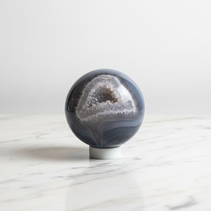 Natural agate crystal sphere with striking banded layers in grey and earth tones, 433g, for grounding, balance and stability