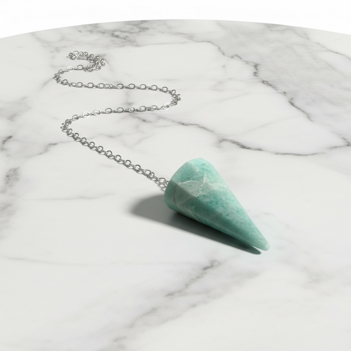 Amazonite Pendulum crystal on white background — smooth blue-green stone with natural variations