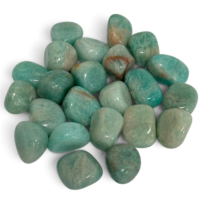 Kindred Crystal Collective — Amazonite Tumbled 2–2.5cm, polished sea-green and turquoise stones with creamy streaks and occasional earthy patches on a white background.