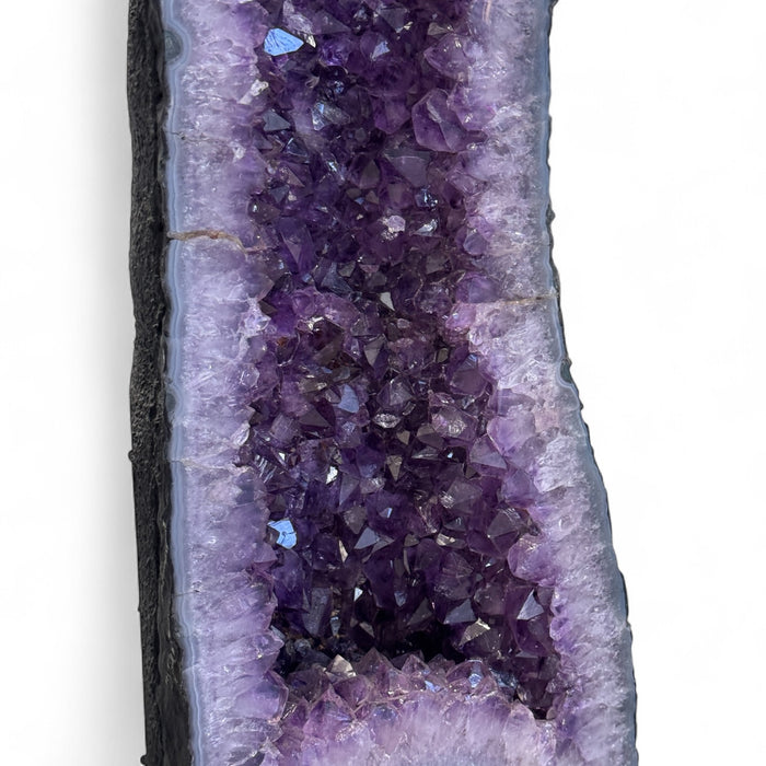 Kindred Crystal Collective — Amethyst Cave Uruguayan, interior view of sparkling deep violet Uruguayan amethyst crystal points within polished cave