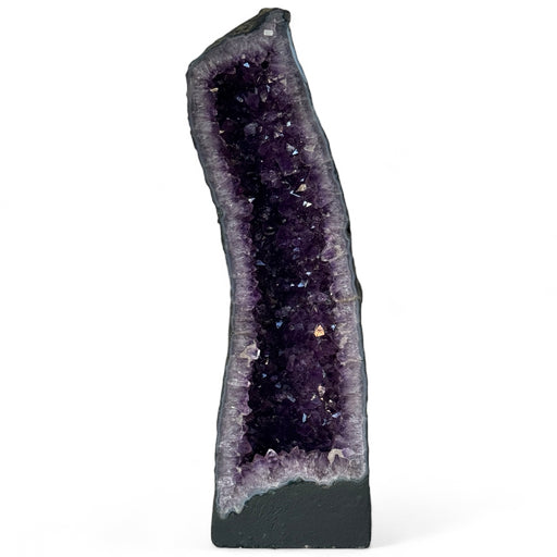 Kindred Crystal Collective — Amethyst Cave With Calcite Inclusion, interior view of sparkling deep violet amethyst crystal points with creamy white calcite formation