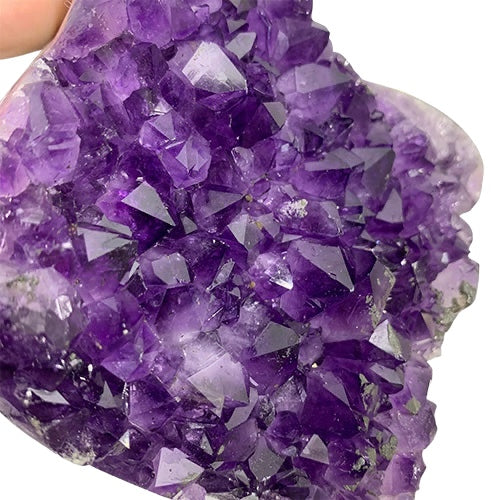Kindred Crystal Collective — Amethyst Cluster, close-up of densely packed deep violet Amethyst crystal points with natural lustre and well-defined terminations, hand-held