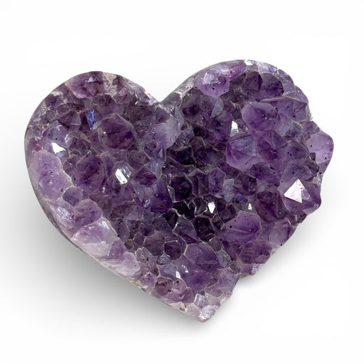 Kindred Crystal Collective — Amethyst Cluster Heart, natural Amethyst druzy heart carving showing violet and lavender crystal points with polished edge, flat lay on white background