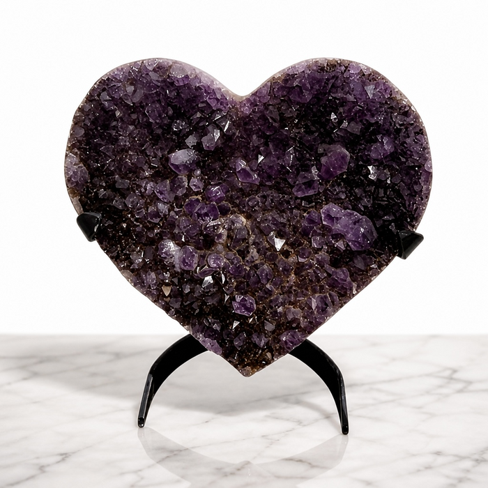 Kindred Crystal Collective — Amethyst Cluster Heart, natural amethyst cluster carved into heart shape with deep violet druzy crystal surface on metal display stand, 24.5cm tall