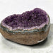 Kindred Crystal Collective — Amethyst Cluster Geode Heart, heart-shaped stone filled with sparkling purple crystal clusters and framed by a polished banded rim.