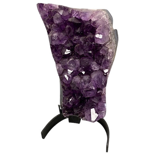 Kindred Crystal Collective — Amethyst Cluster on Stand, statement-grade natural Amethyst crystal cluster on black metal stand showing deep indigo-violet points and raw matrix edge, white background