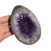 Kindred Crystal Collective — Amethyst Druzy Egg, hand-held polished dark grey Amethyst druzy egg tilted to show full egg silhouette and violet crystal interior, size reference