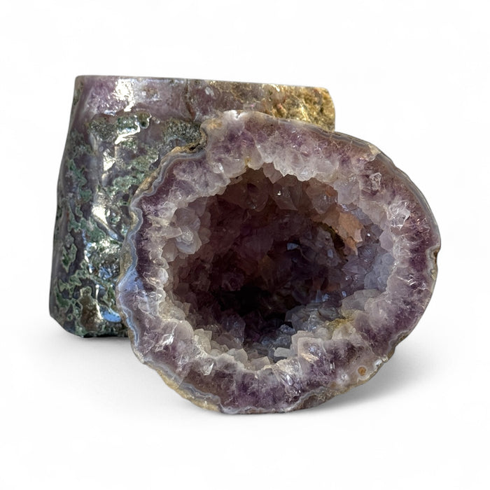 Kindred Crystal Collective — Amethyst Geode Pair, matched natural amethyst geode pair with deep violet druzy crystal interiors displayed side by side