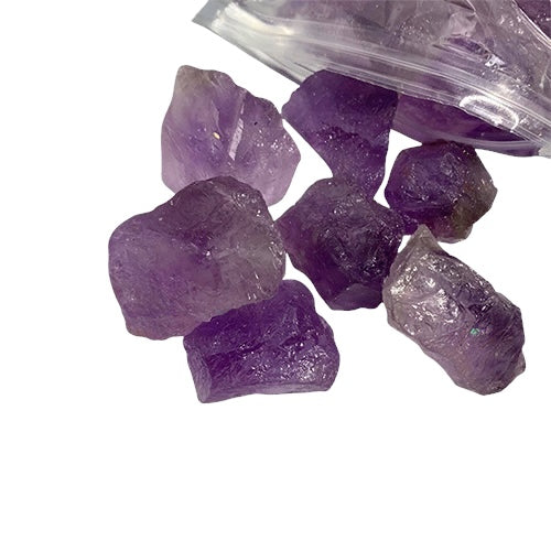 Kindred Crystal Collective — Amethyst Rough 1KG AA+ Grade, rich violet raw amethyst chunks spilling from a clear bag on white background.