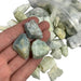 Kindred Crystal Collective — Aquamarine Rough 1KG, soft blue raw aquamarine chunks spilling from a clear bag on white background.
