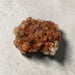Mineral sample on a textured gray surface