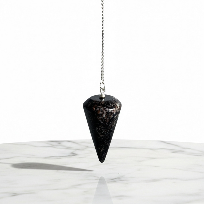 Natural astrophyllite faceted pendulum with dark base and golden-bronze metallic inclusions, used for dowsing and energy work