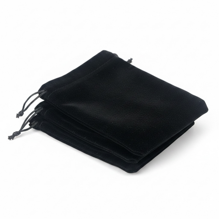 Stack of black velvet drawstring bags on a white background