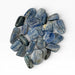 Kindred Crystal Collective — Blue Kyanite Tumbled Stones, large group of polished steel-blue to mid-blue Kyanite tumbles showing characteristic parallel fibrous striations across each stone surface, white background