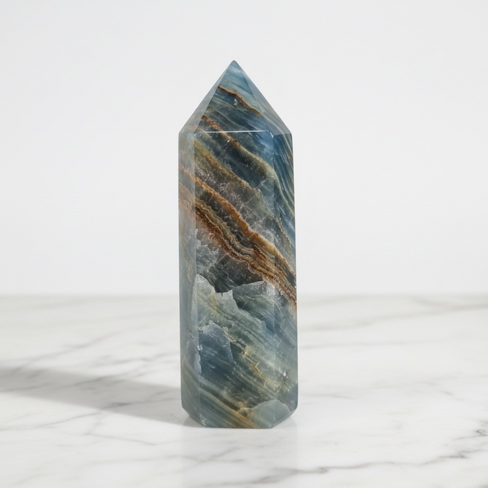 Blue onyx generator 328g with polished pointed apex and deep blue banding, a calming crystal tower for concentration and positive energy