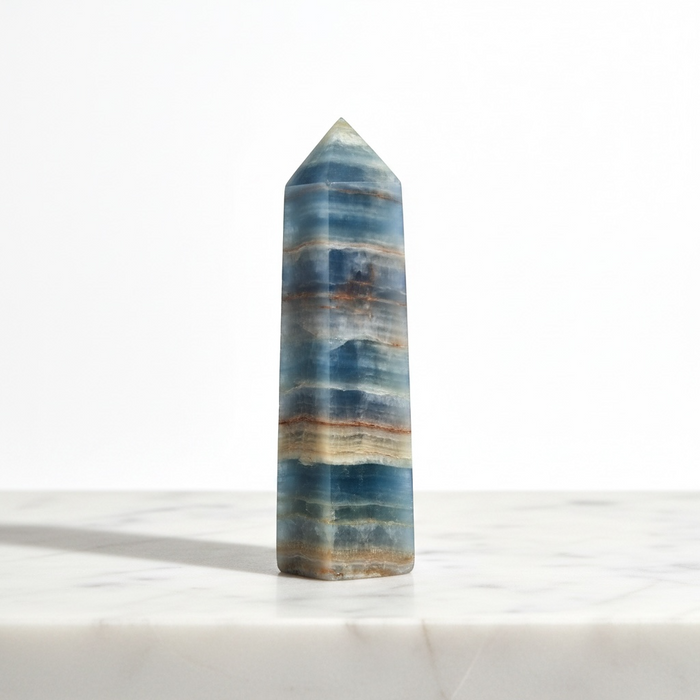 Natural blue onyx obelisk 96g in deep blue tones, a calming crystal tower for throat chakra and emotional steadiness