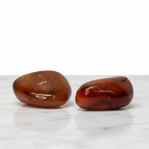 Two carnelian stones on a white background
