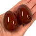 Kindred Crystal Collective — Carnelian Egg, two polished deep reddish-brown crystal eggs 