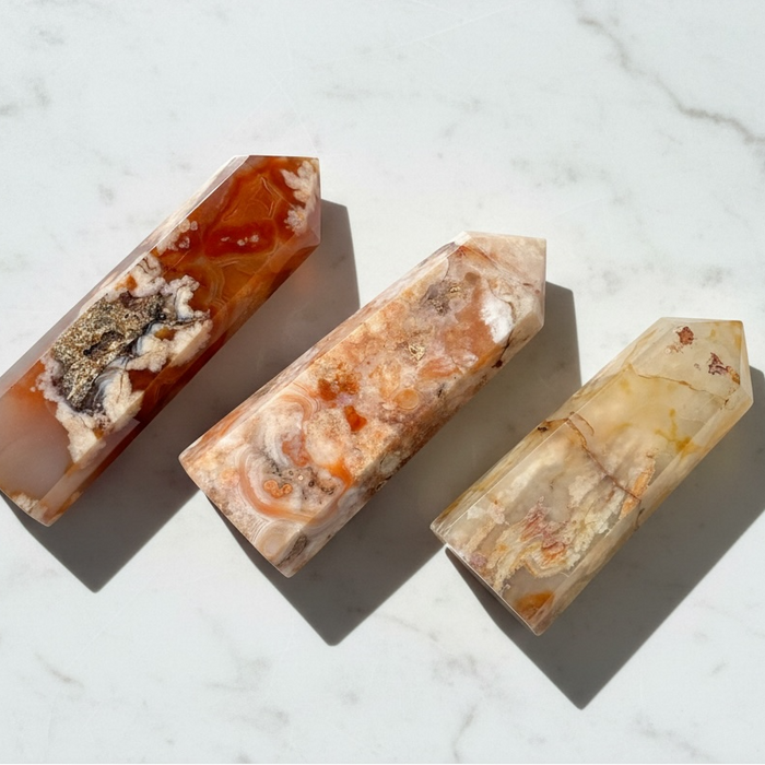 Three crystal stones on a marble surface