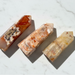 Three crystal stones on a marble surface
