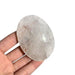 Kindred Crystal Collective — Clear Quartz Palm Stone, polished oval clear-to-cloudy quartz with visible internal inclusions held in a hand.”