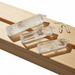 Clear crystal points on a wooden surface with a white background