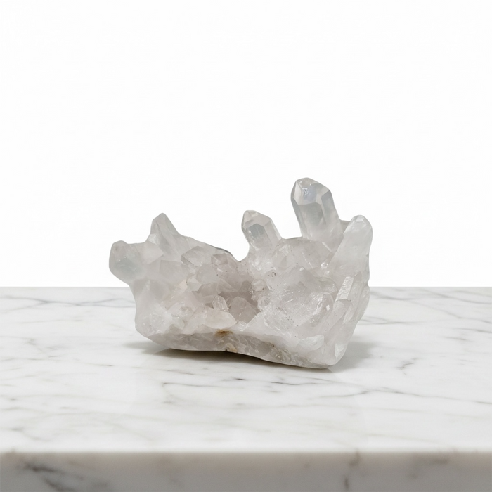 Kindred Crystal Collective — Clear Quartz Cluster, natural transparent quartz cluster with multiple points radiating from shared base, white background