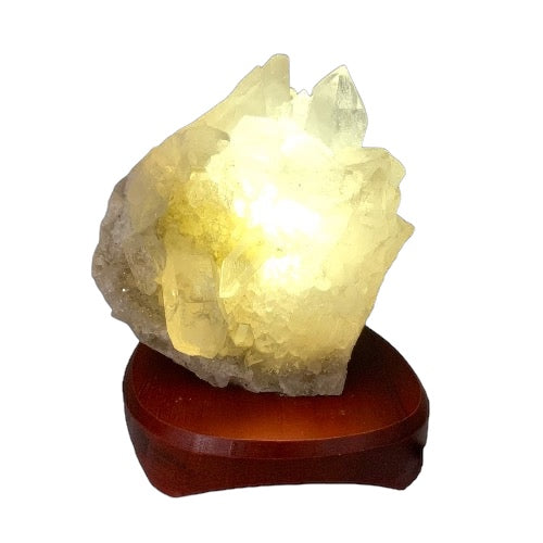 Kindred Crystal Collective — Clear Quartz Cluster Lamp, natural clear quartz cluster illuminated with warm LED glow on timber base