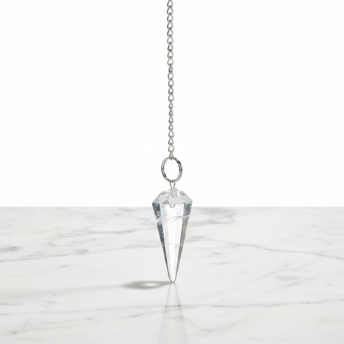 Natural clear quartz faceted pendulum in transparent crystal, used for dowsing, manifestation and crown chakra healing