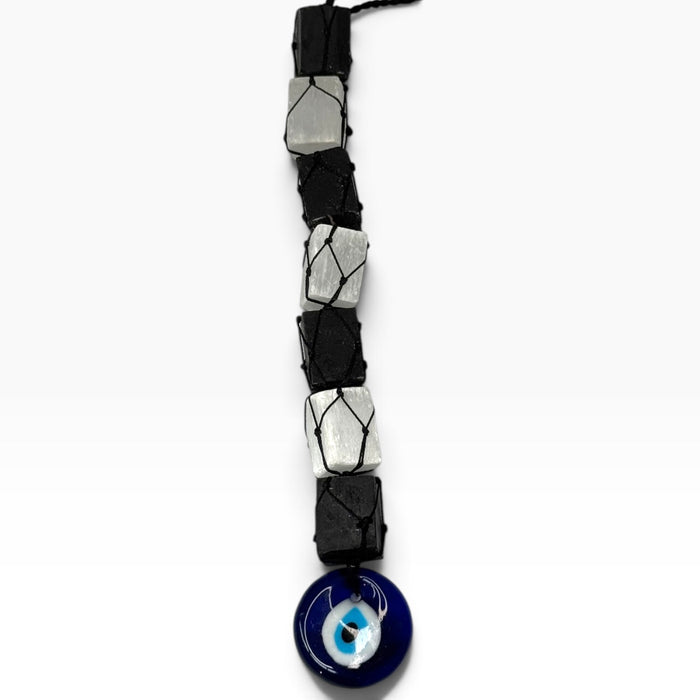 Kindred Crystal Collective — Evil Eye Tourmaline Selenite Macrame Hanger, alternating black tourmaline and white selenite held in black cord with a blue evil-eye charm.