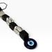 Kindred Crystal Collective — Evil Eye Tourmaline Selenite Macrame Hanger, alternating black tourmaline and white selenite held in black cord with a blue evil-eye charm.