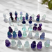 Kindred Crystal Collective — Fluorite Chess Set, pastel fluorite chess pieces arranged on board showing soft lavender and mint green natural banding