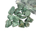 Kindred Crystal Collective — Fuchsite Rough 1KG, sparkling emerald-green raw fuchsite chunks spilling from a clear bag on white background.

