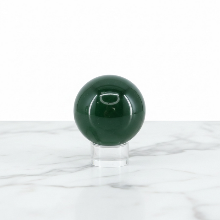 Kindred Crystal Collective — Green Obsidian Sphere, polished deep forest green glass sphere, on a clear display stand
