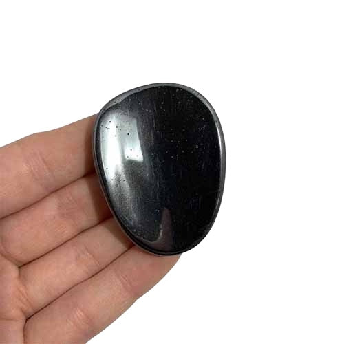 Kindred Crystal Collective — Hematite Worry Stone, dark metallic-grey natural stone with a smooth rounded shape for comfortable holding.
