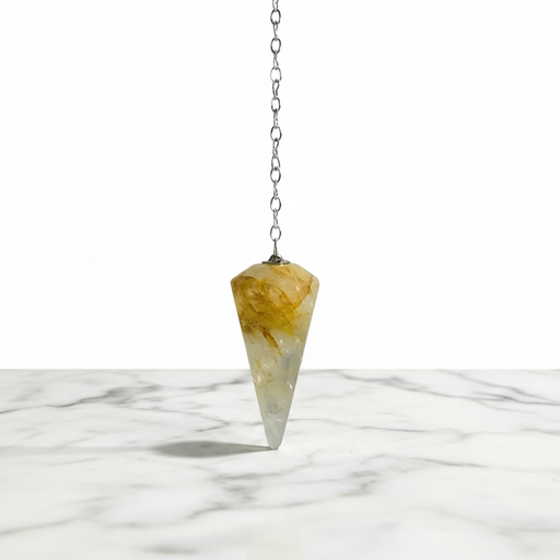 Hematoid Quartz Pendulum crystal on white background — clear quartz with red-brown Hematite inclusions