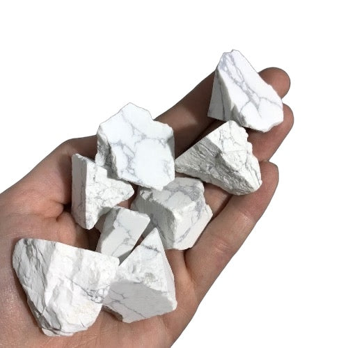 Kindred Crystal Collective — White Howlite Rough 1KG, white and grey veined raw howlite chunks spilling from a clear bag on white background.