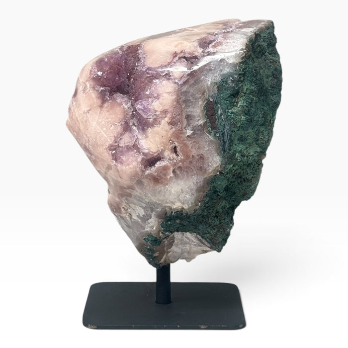 Kindred Crystal Collective — Pink Amethyst Geode on Metal Stand, substantial pink-to-lilac crystal geode displayed on a metal stand with natural mineral variation