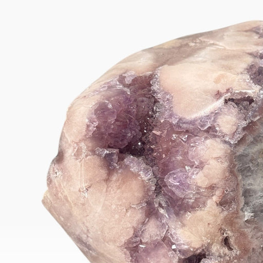 Kindred Crystal Collective — Pink Amethyst Geode on Metal Stand, substantial pink-to-lilac crystal geode displayed on a metal stand with natural mineral variation