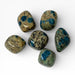 Kindred Crystal Collective — K2 Stone Tumbled Stones, six polished K2 granite tumbles showing cream-beige speckled granite matrix with vivid teal-blue Azurite spots, white background