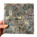 Kindred Crystal Collective — Labradorite Tile Purple Flash, angled view of polished labradorite tile showing shifting blue, gold and purple iridescent flash