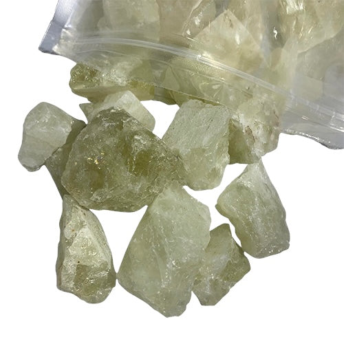 Kindred Crystal Collective — Lemon Quartz Rough 1KG, pale yellow-green raw lemon quartz chunks spilling from a clear bag on white background

