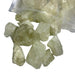 Kindred Crystal Collective — Lemon Quartz Rough 1KG, pale yellow-green raw lemon quartz chunks spilling from a clear bag on white background

