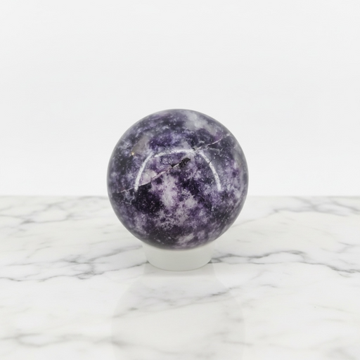 Kindred Crystal Collective — Lepidolite Sphere, polished speckled purple and lavender lepidolite sphere on clear display stand, white background