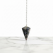Llanite Pendulum crystal on white background also known as Que Sera, with blue and pink tones