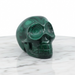 Malachite skull 180g showing striking green concentric banding, a powerful stone of transformation for third eye and heart chakra activation