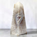 Kindred Crystal Collective — Natural Agate Druzy Obelisk, polished cream-toned crystal tower with flowing grey bands and natural crystalline textures.