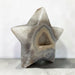Kindred Crystal Collective — Natural Agate Druzy Star, polished five-point agate star with cream and grey banding surrounding a sparkling druzy cavity, on a light surface.