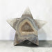Kindred Crystal Collective — Natural Agate Druzy Star, polished five-point agate star with cream and grey banding surrounding a sparkling druzy cavity, on a light surface.